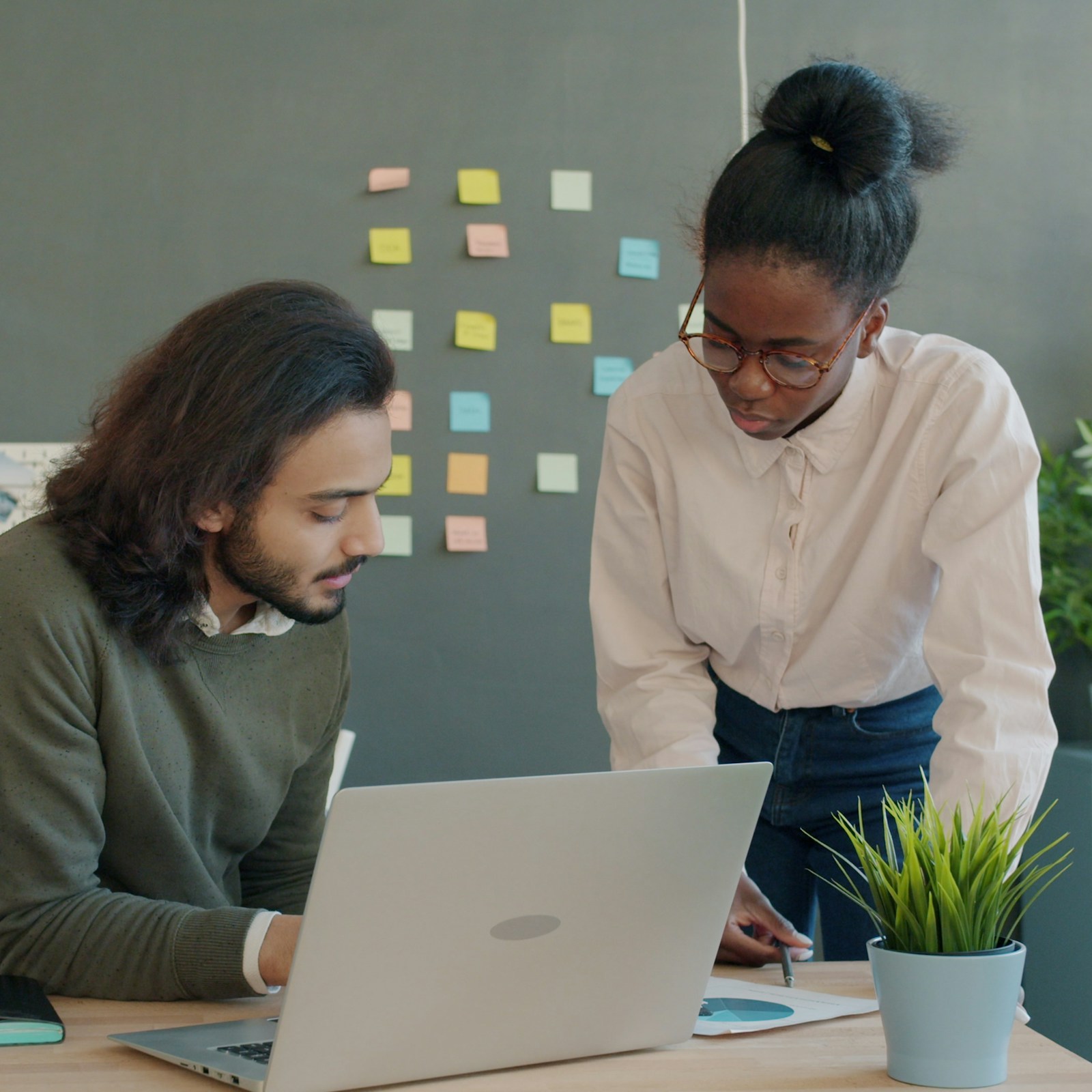 Two people discussing a project together in person